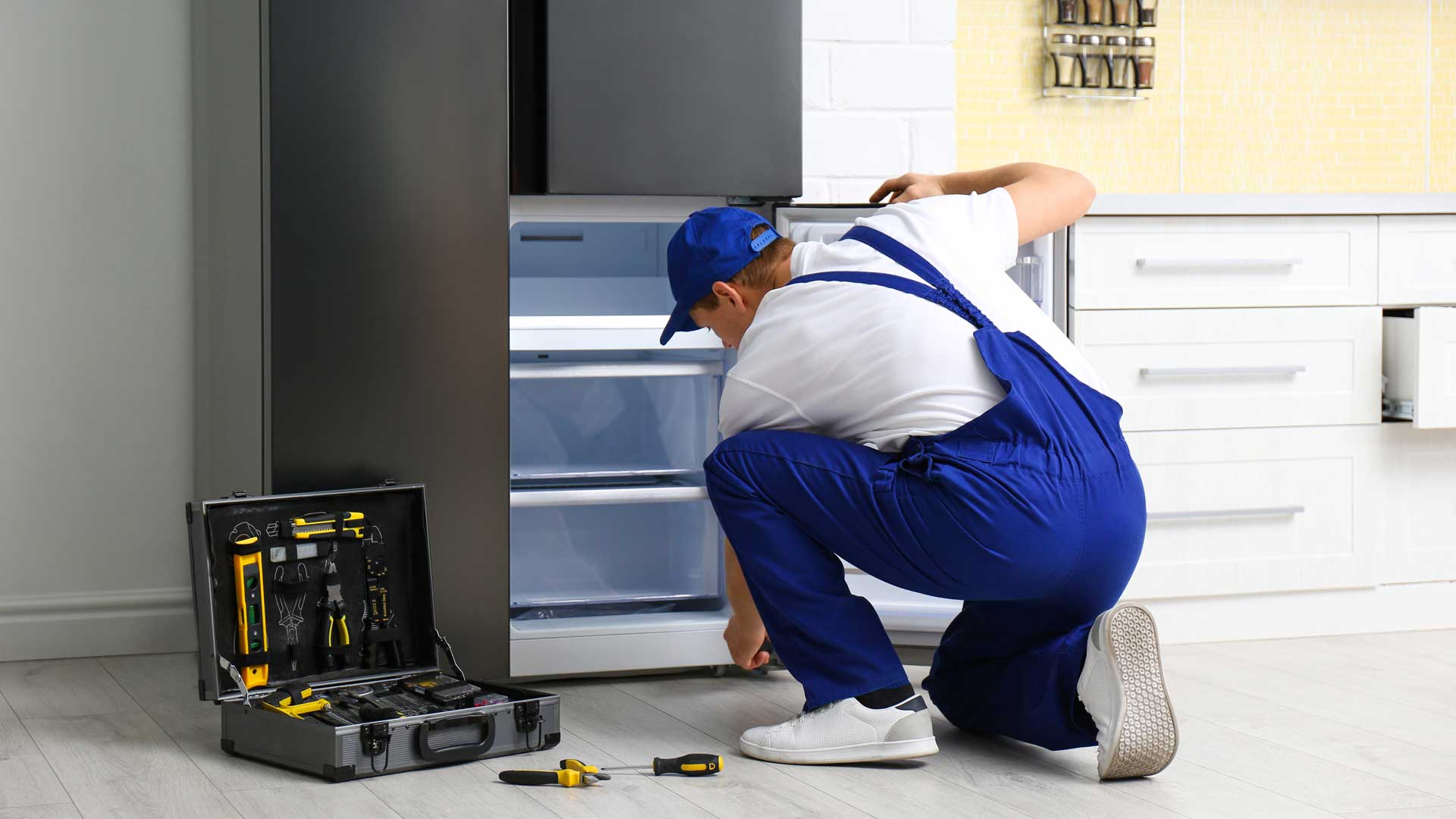 Repair technician working on a refrigerator